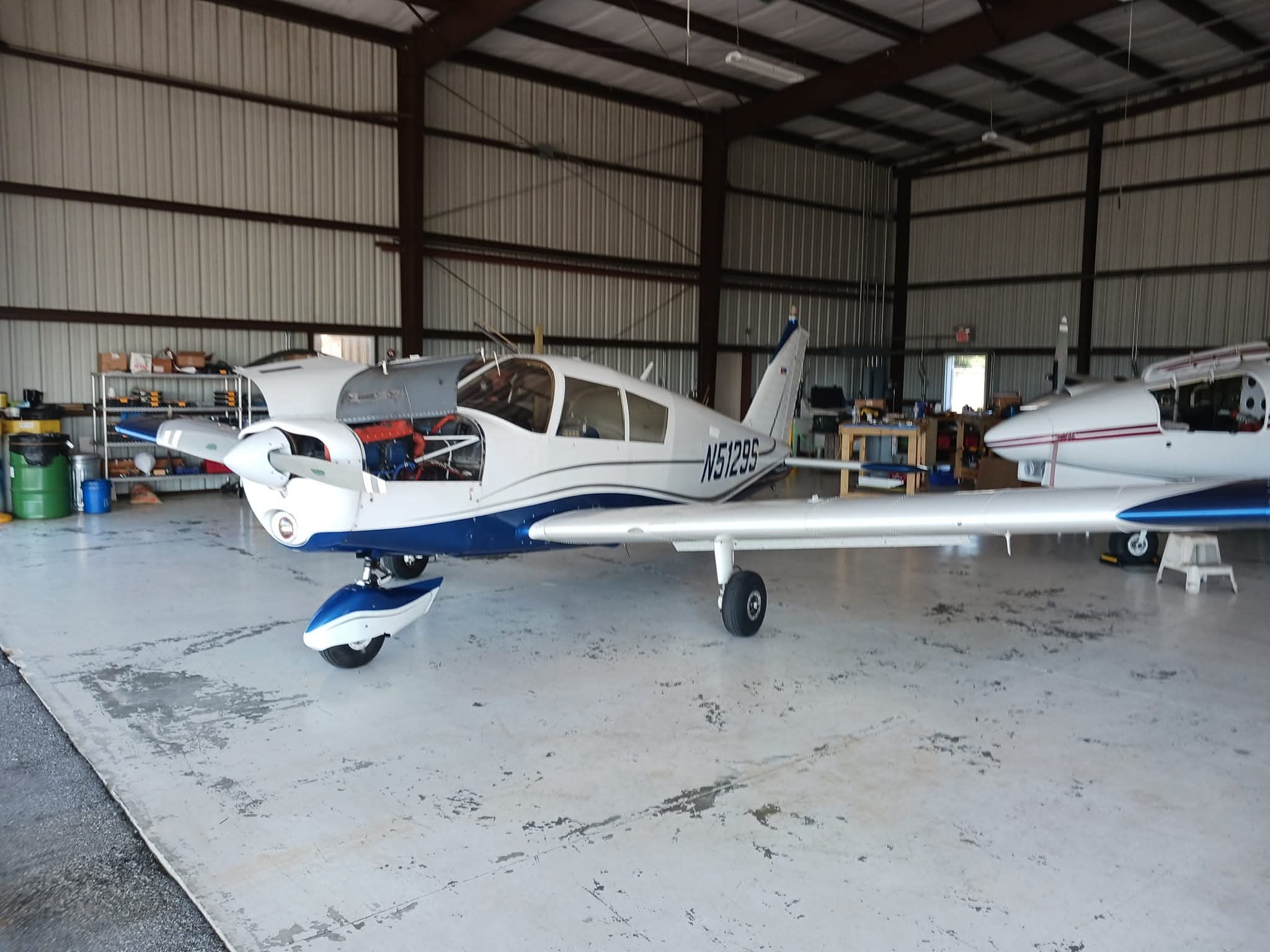 Piper Cherokee in the hangar for inspection